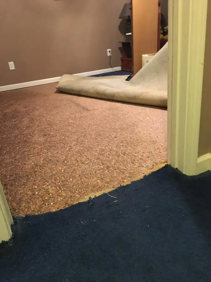 Carpet pad removal revealing water damage during Water Mitigation Services in Lincolnton